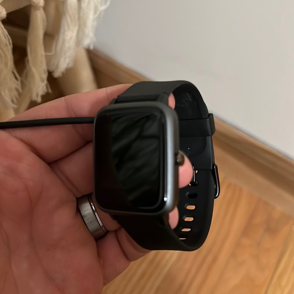 Smart watch w/charger. Works with iPhone or android.